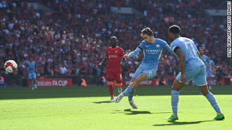 Grealish shoots and scores City&#39;s first goal during the English FA Cup semifinal against Liverpool on April 16, 2022. 