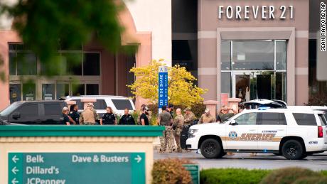 Law enforcement gather outside the Columbiana Center mall on Saturday.