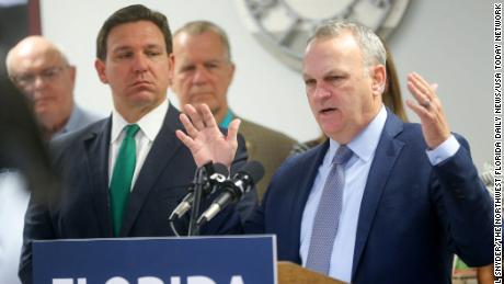 Florida Department of Education Commissioner Richard Corcoran, right, alongside Gov. Ron DeSantis, speaks at a news conference in March.