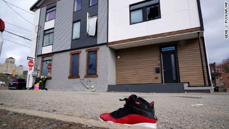 A lone sneaker lies near a short-term rental property where police say a shooting took place in Pittsburgh early Sunday morning, April 17, 2022. The shooting happened around 12:30 a.m. during a party at a short-term rental property where there were more than 200 people inside — many of them underage, Pittsburgh police said in a news release. 