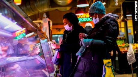 FILE - Customers wear face masks to protect against the spread of the coronavirus as they shop at the Reading Terminal Market in Philadelphia, Feb. 16, 2022.  COVID cases are starting to rise again in the United States, with numbers up in most states and up steeply in several. One expert says he expects more of a &quot;bump&quot; than the monstrous surge of the first omicron wave, but another says it&#39;s unclear how high the curve will rise and it may be more like a hill. (AP Photo/Matt Rourke, File)