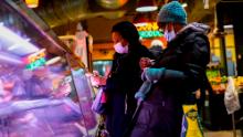 FILE - Customers wear face masks to protect against the spread of the coronavirus as they shop at the Reading Terminal Market in Philadelphia, Feb. 16, 2022.  COVID cases are starting to rise again in the United States, with numbers up in most states and up steeply in several. One expert says he expects more of a &quot;bump&quot; than the monstrous surge of the first omicron wave, but another says it&#39;s unclear how high the curve will rise and it may be more like a hill. (AP Photo/Matt Rourke, File)