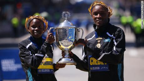 Kenya&#39;s Evans Chebet (R) and Peres Jepchirchir (L) celebrate with the Boston Marathon trophy after winning the elite men&#39;s and women&#39;s races.