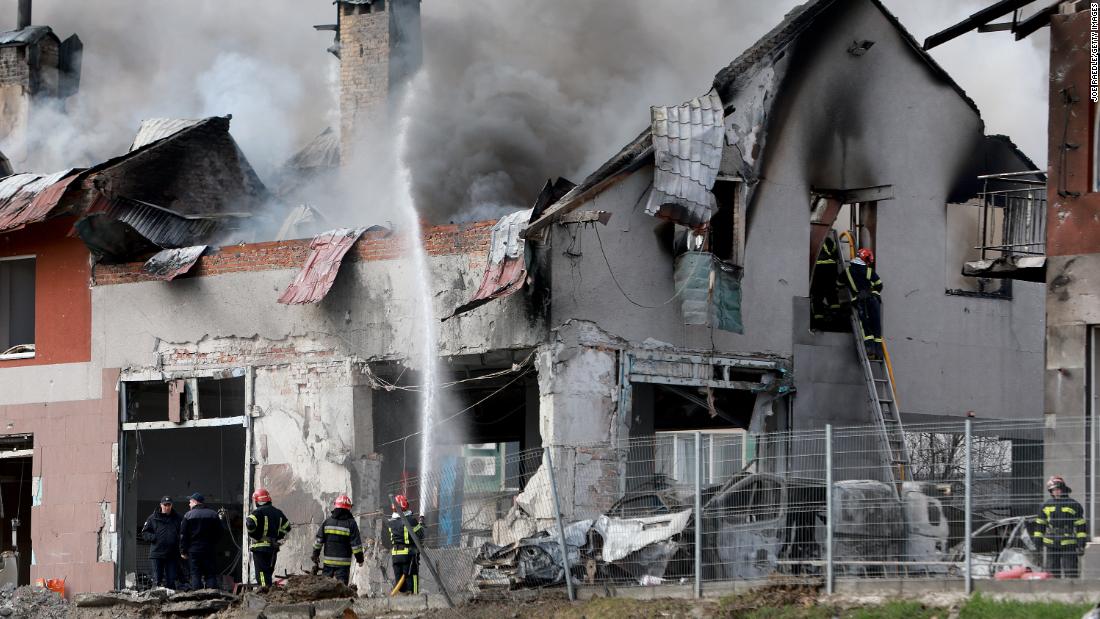 Firefighters work in Lviv after a civilian building was hit by a Russian missile on April 18.