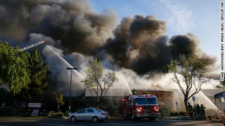 Firefighters work on a five-alarm fire at the Home Depot in San Jose, California, on April 9.