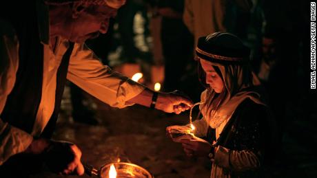 Iraqi Yazidis light candles outside the Lalish temple in a valley near the Kurdish city of Dohuk on April 19, during a ceremony marking the Yazidi New Year. About 1.6 million Yazidis commemorate the arrival of light into the world during the New Year celebrations.