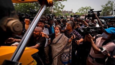 Communist Party of India leader Brinda Karat, center, stands in front of a bulldozer during the demolition of Muslim-owned shops in New Delhi&#39;s northwest Jahangirpuri neighborhood, in New Delhi, India, Wednesday, April 20, 2022. 