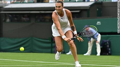 Belarus'  Aryna Sabalenka hits a return to Romania's Monica Niculescu during their women's singles first round match at the 2021 Wimbledon Championships.