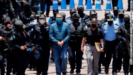 Juan Orlando Hernandez is escorted by police to be extradited to the United States, on April 21, 2022 in Tegucigalpa, Honduras.