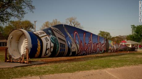 A turbine blade lies outside the Weatherford city hall. A local artist is in the process of painting a mural on it.