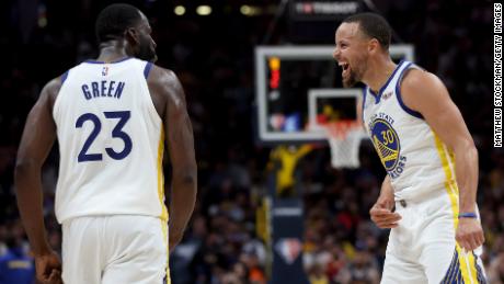 Draymond Green and Steph Curry celebrate against the Denver Nuggets.