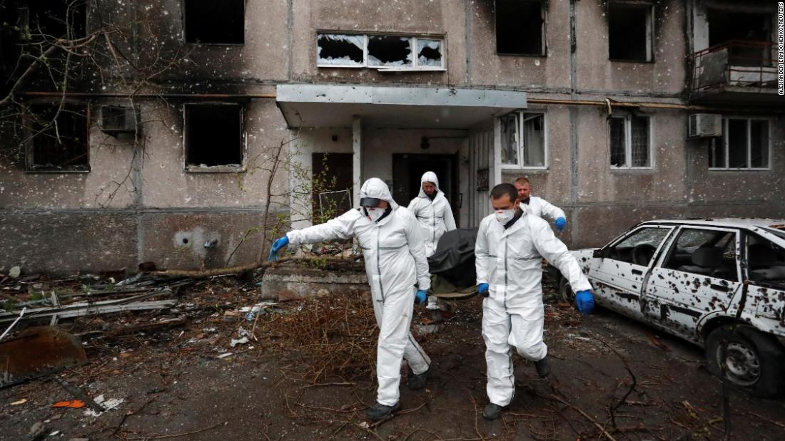 Emergency workers remove the body of a person killed during the &lt;a href=&quot;https://us.cnn.com/2022/04/22/europe/mariupol-ukraine-russia-intl-hnk/index.html&quot; target=&quot;_blank&quot;&gt;Russian attack on Mariupol.&lt;/a&gt;