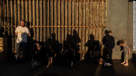 Ukrainians wait in Tijuana, Mexico, to cross into the United States, on March 23. The US government is now advising Ukrainians not to travel to Mexico to reach the US, as the Biden administration rolls out a new program to streamline the admission process for those seeking refuge from the Russian invasion.