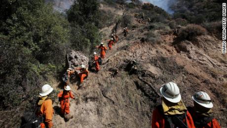 An inmate firefighter hand crew works during the Palisades Fire, in the Pacific Palisades neighborhood, on October 21, 2019, in Los Angeles.