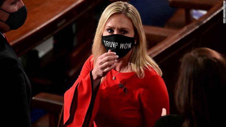 Rep. Marjorie Taylor Greene (R-GA) wears a &quot;Trump Won&quot; face mask as she arrives on the floor of the House to take her oath of office as a newly elected member of the 117th House of Representatives in Washington, U.S., January 3, 2021.  