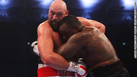Fury holds onto Dillian Whyte during the fight. 