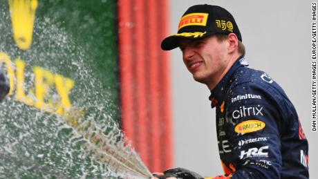 Race winner Max Verstappen celebrates on the podium.