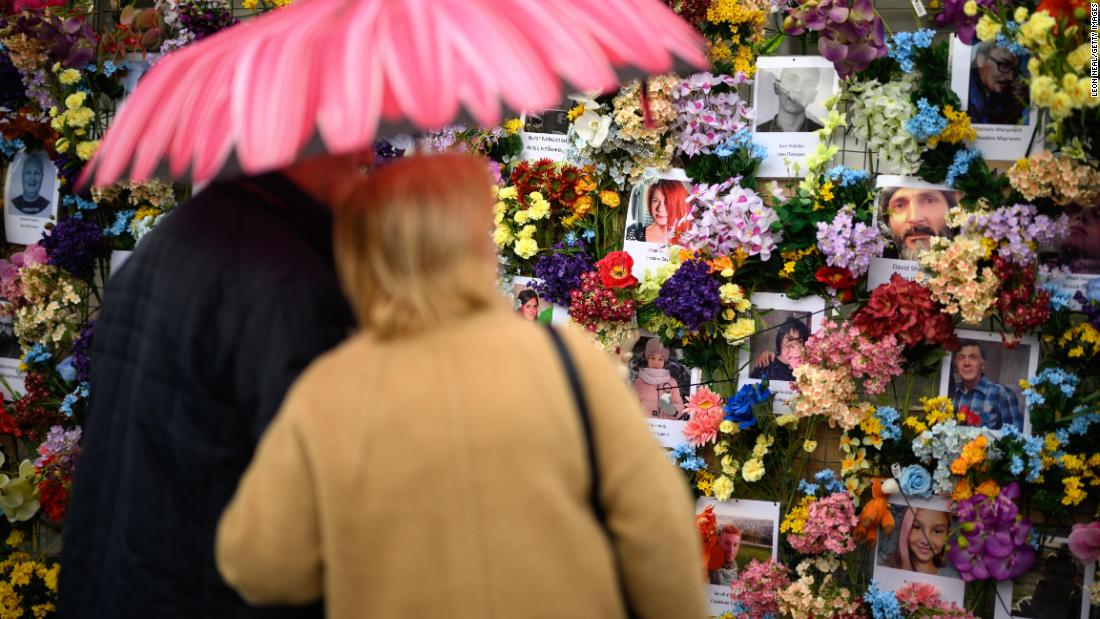 A couple looks at a memorial wall in Lviv on April 24. The wall shows Ukrainian civilians who have been killed during the Russian invasion.