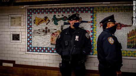 Police officers standing inside the Harlem 125 Street Station.