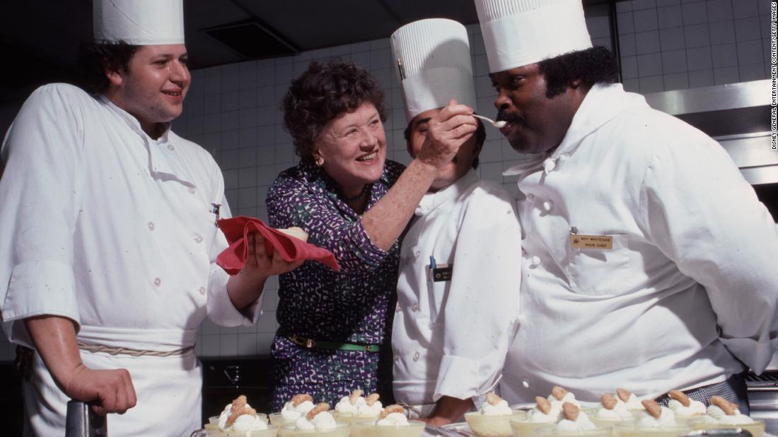Child feeds a fellow chef in 1979.