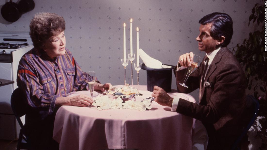 Child and actor George Hamilton dine together in 1983.