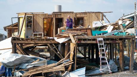 A resident of Grand Isle, Louisiana looks through his home after Category 4 Hurricane Ida made landfall in August 2021.