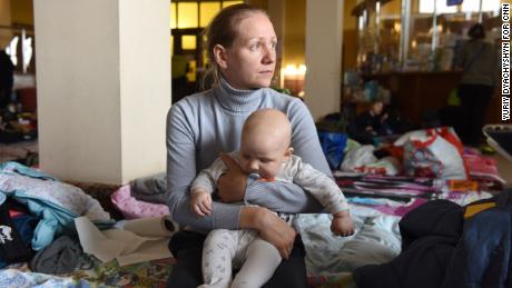 Ksenia, a 32-year-old from Kyiv, cradles her 6-month-old son Oleksandr. &quot;The children were waking up at night because of explosions, they were scared,&quot; she said, describing the days before they fled.