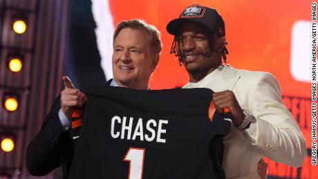Ja&#39;Marr Chase poses with NFL Commissioner Roger Goodell after being selected fifth by the Cincinnati Bengals during the 2021 NFL Draft.