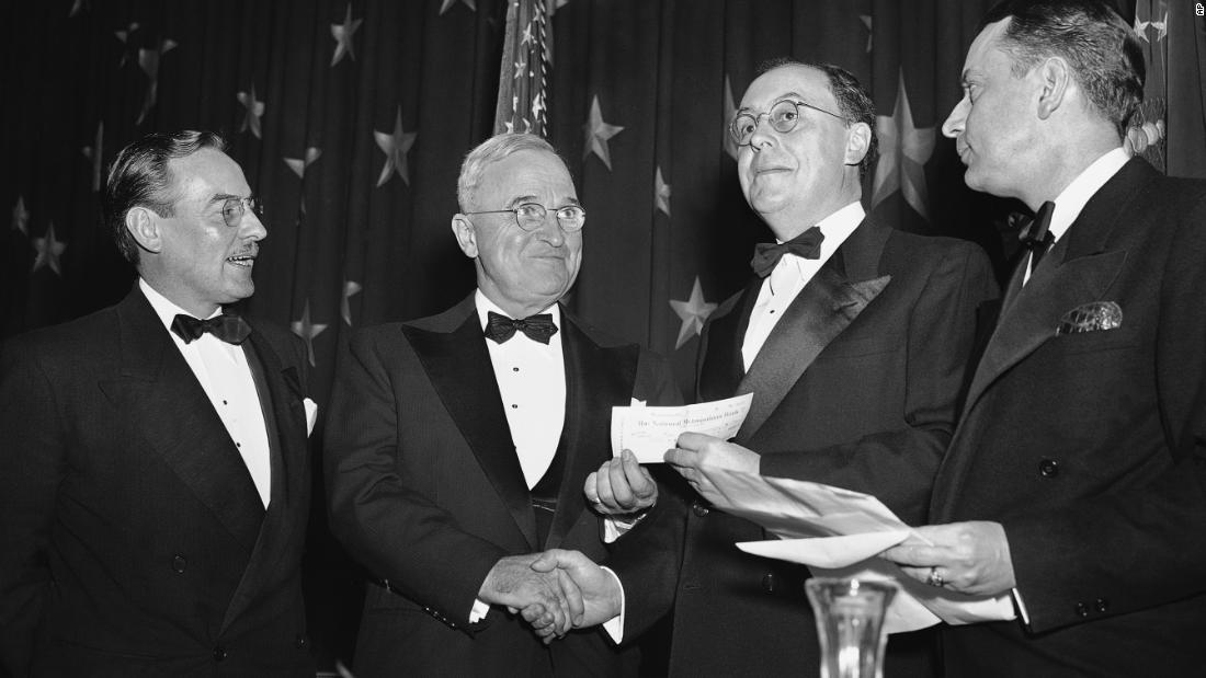 President Harry Truman, second from left, presents a $500 check to Peter Edson, second from right, for winning the Raymond Clapper Memorial Award in 1949.