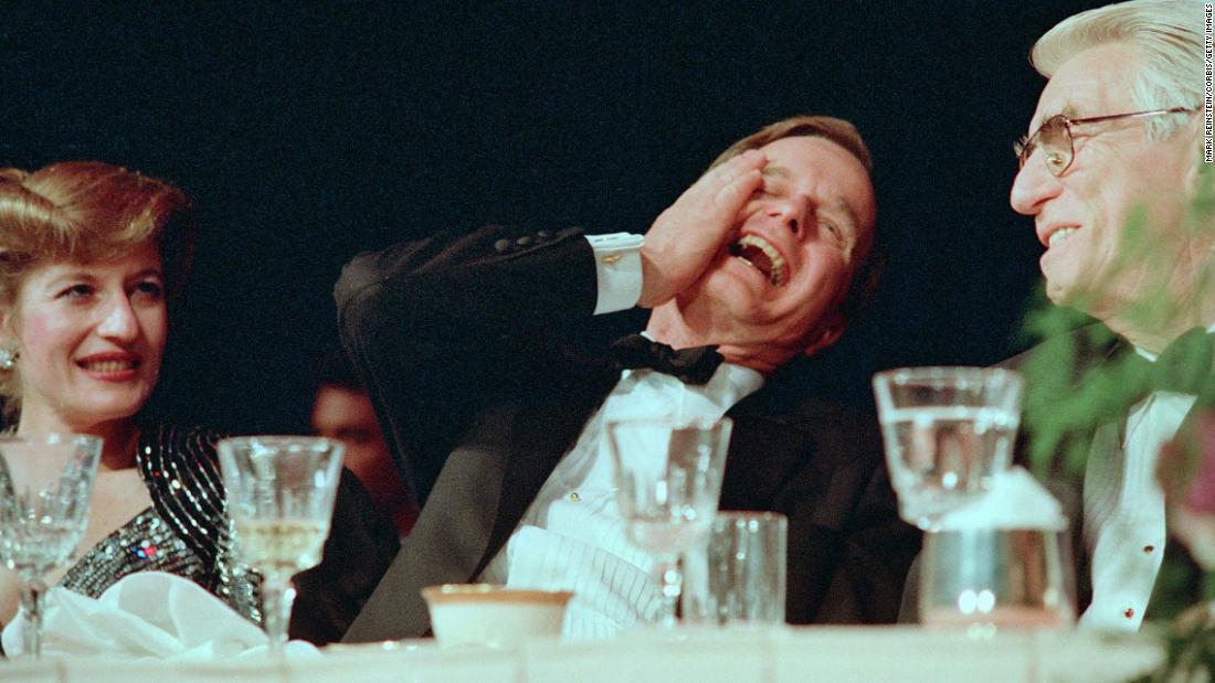 President George H.W. Bush laughs while watching Jim Morris do an impression of him at the 1989 dinner.