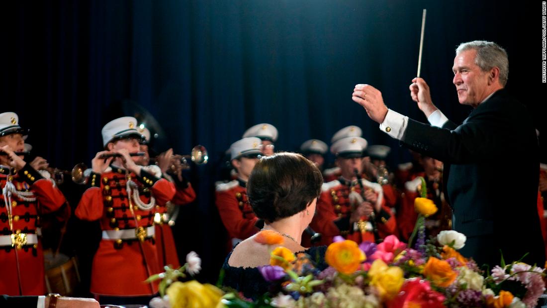 President George W. Bush conducts the Marine Corps Band during the dinner in 2008.