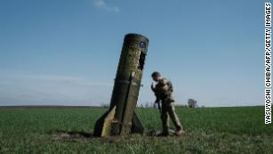 TOPSHOT - A Ukrainian serviceman looks at a Russian ballistic missile&#39;s booster stage that fell in a field in Bohodarove, eastern Ukraine, on April 25, 2022, amid the Russian invasion of Ukraine. (Photo by Yasuyoshi CHIBA / AFP) (Photo by YASUYOSHI CHIBA/AFP via Getty Images)