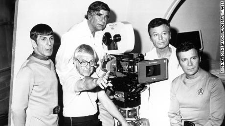 Actors Leonard Nimoy, DeForest Kelley and William Shatner pose for a photo with "  Star Trek "  Creator Gene Roddenberry, poser, and director Robert Wise, left of the camera, during the filming of the 1979 film, '  Star Trek: The Motion Picture.  & quot; 
