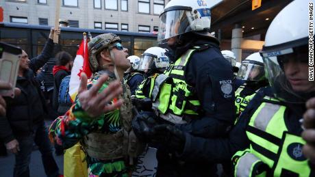A supporter of the Rolling Thunder Convoy confronts a riot police officer during a protest on Friday in Ottawa, Canada.