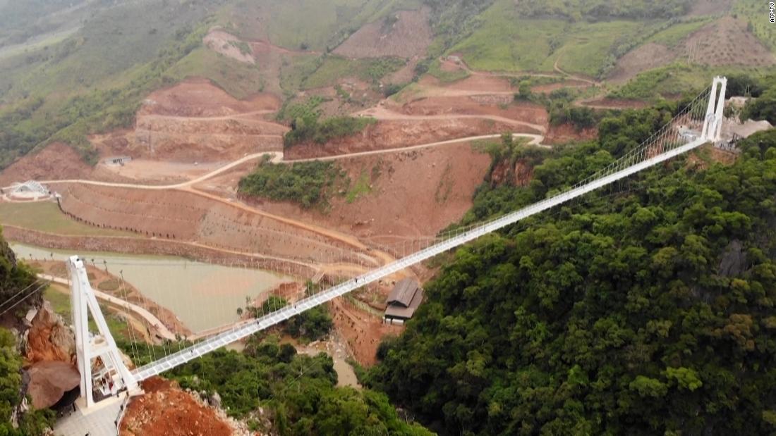 New glass bridge in Vietnam suspends visitors between two mountains – CNN Video