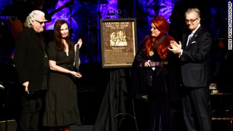 Wynonna Judd, second from the right, stands next to The Judds&#39; induction plaque as sister Ashley Judd, left, Ricky Skaggs, and MC Kyle Young, CEO of the Country Music Hall of Fame &amp; Museum look on during the Medallion Ceremony at the Country Music Hall of Fame on Sunday.