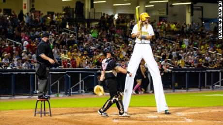 A Bananas player steps up to bat in stilts.