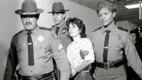 In this Nov. 21, 1981 file photo, Weather Underground member Katherine Boudin is led from Rockland County Courthouse in New City, New York, by sheriff&#39;s officers.