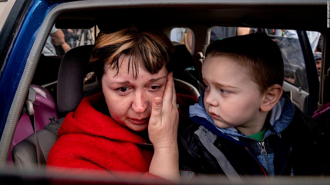 Natalia Pototska cries next to her grandson Matviy as they arrive at a center for displaced people in Zaporizhzhia on May 2.