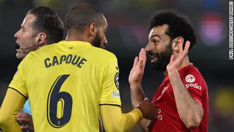 Salah argues with Capoue during the game.