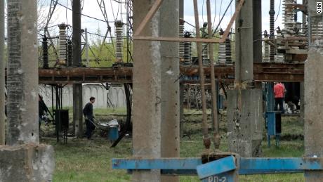 Railway workers remove debris from a power station in Lviv.