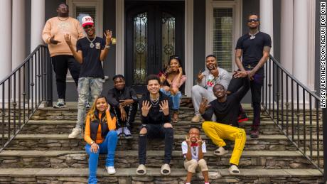 From left, Robert Dean III, Tray Bills, Khamyra Sykes, Oneil Rowe, Noah Webster, Kaychelle Dabney, Marcus Bolton, manager Keith Dorsey, Theodore Wisseh and Cameron Lee pose for a photo outside of the Collab Crib in Fayetteville, Georgia. Missing is the house&#39;s 10th creator, Kaelyn Castle. 