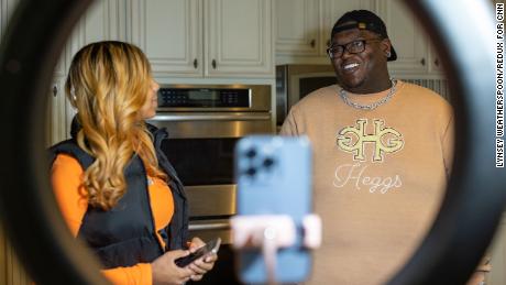 Khamyra Sykes and Robert Dean work on a TikTok video together in the home&#39;s kitchen.