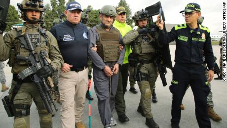 Police escort Dairo Antonio Usuga, center, also known as &quot;Otoniel,&quot; at an airport in Colombia before his extradition to the US