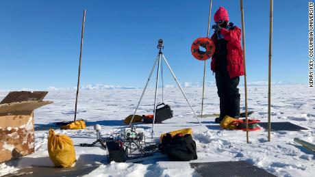 Researcher Chloe Gustafson, of UC San Diego&#39;s Scripps Institution of Oceanography, prepares to install a magnetotelluric station to map beneath the ice during 2018 field work in Antarctica. 