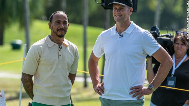 Mercedes' British driver Lewis Hamilton (L) and and NFL quarterback Tom Brady attend the Big Pilot Charity Challenge at the Miami Beach Golf Club, in Miami Beach, Florida on May 4, 2022.