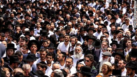 Israelis take part in the funeral service of Yonatan Havakuk and Boaz Gol, killed in the attack.