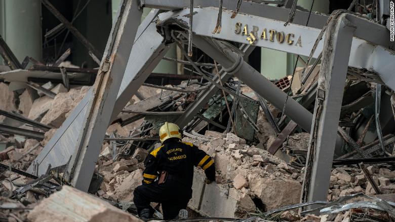 A sign from Hotel Saratoga is seen in the rubble after the building was destroyed by an explosion in Havana, Cuba, on Friday, May 6.