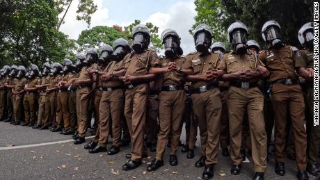 Sri Lankan police officers attend a demonstration near the parliament building in Colombo by protesters demanding President Gotabaya Rajapaksa&#39;s resignation on May 4.