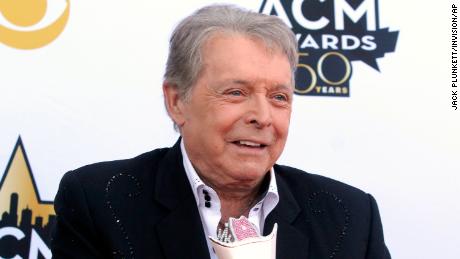 Mickey Gilley poses with the Triple Crown Award on the red carpet at the 50th annual Academy of Country Music Awards at AT&amp;T Stadium in Arlington, Texas, April 19, 2015. 